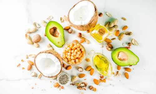 picture of healthy vegan fat sources on a white background.