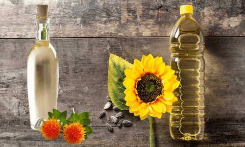 Picture of a bottle of safflower oil and a bottle of sunflower oil side by side on a table. Seed oils: your worst enemy or are they?