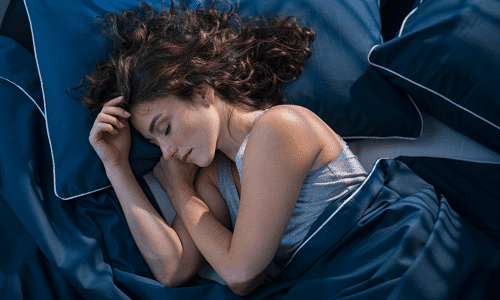 woman sleeping in bed at night. Prioritize sleep to improve insulin resistance.
